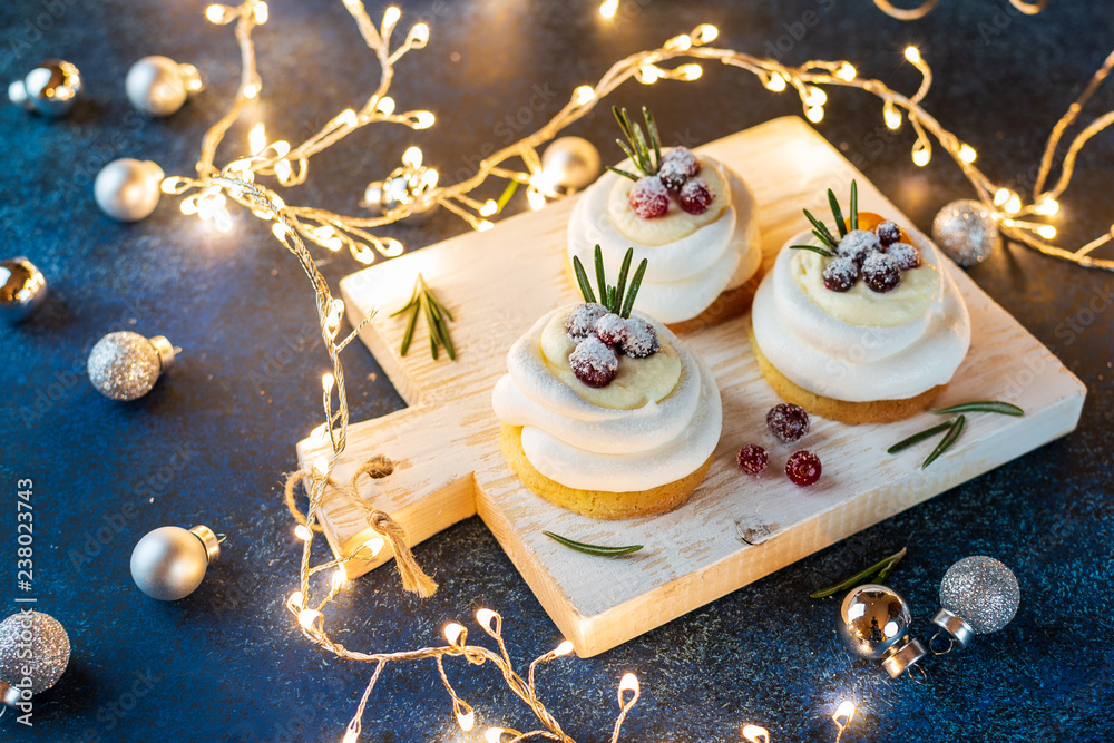 Pavlova Cake with berry cranberries on blue plate