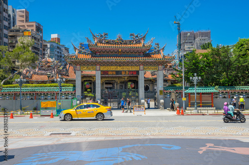 People walking in front of the gate of Longshan Temple in Taipei, Taiwan photo
