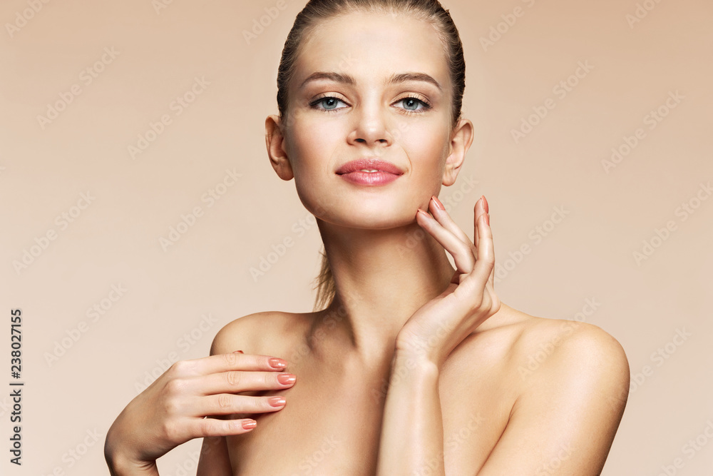 Young pretty girl with naturarl makeup on beige background. Skin care concept Young pretty girl with naturarl makeup on beige background. Skin care concept