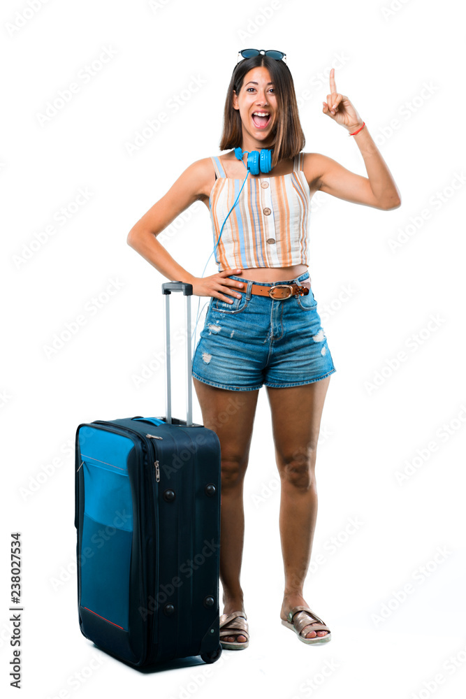 Full body of Girl traveling with her suitcase standing and thinking an idea pointing the finger up on isolated white background Full body of Girl traveling with her suitcase standing and thinking an idea pointing the finger up on isolated white background