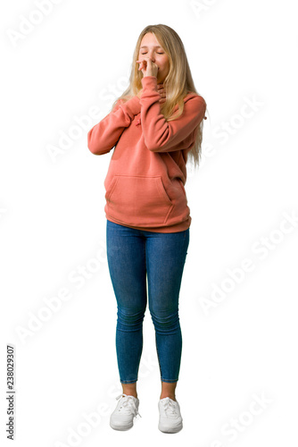 A full-length shot of a Young girl is suffering with cough and feeling bad on isolated white background © luismolinero