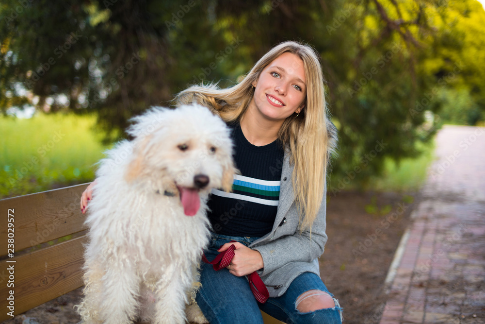 Young girl with her dog in a park Young girl with her dog in a park