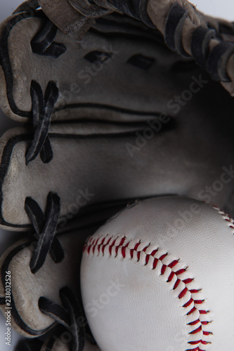 old used baseball glove and ball isolated closeup photo