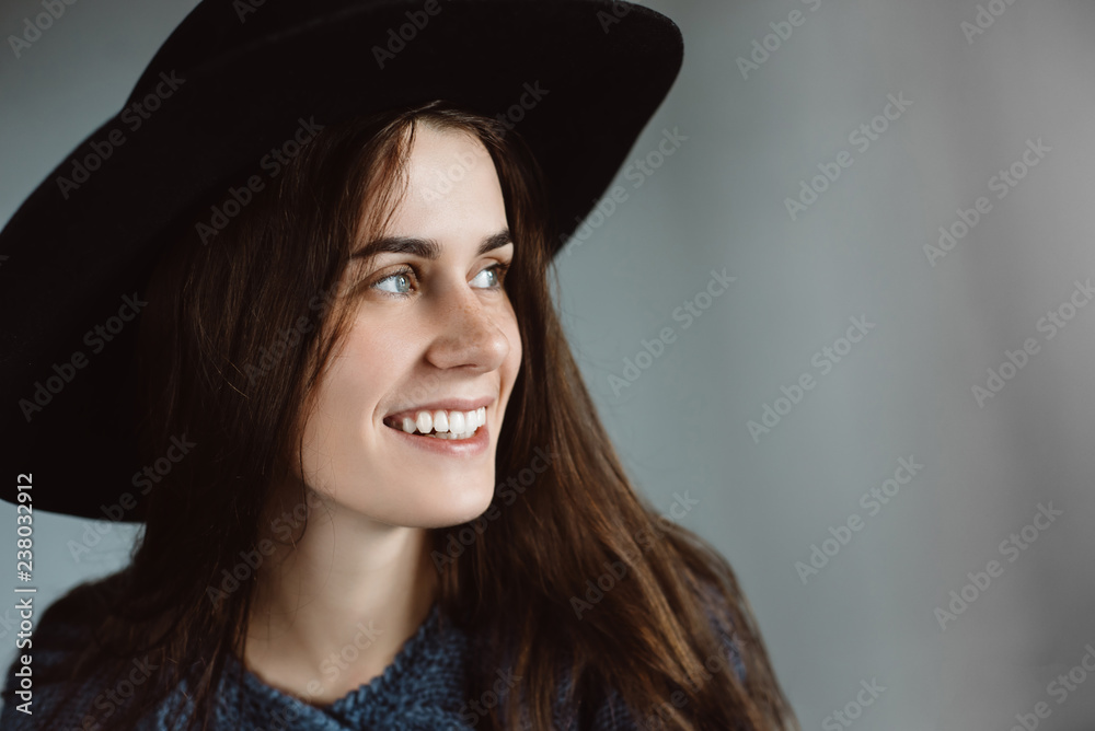 Portrait of beautiful young happy woman wearing black hat . Portrait of beautiful young happy woman wearing black hat .