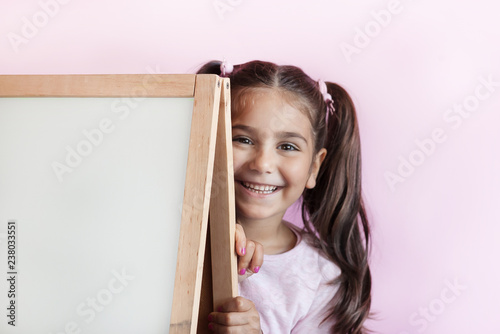 Back to school. Cute little child girl with blackboard. 