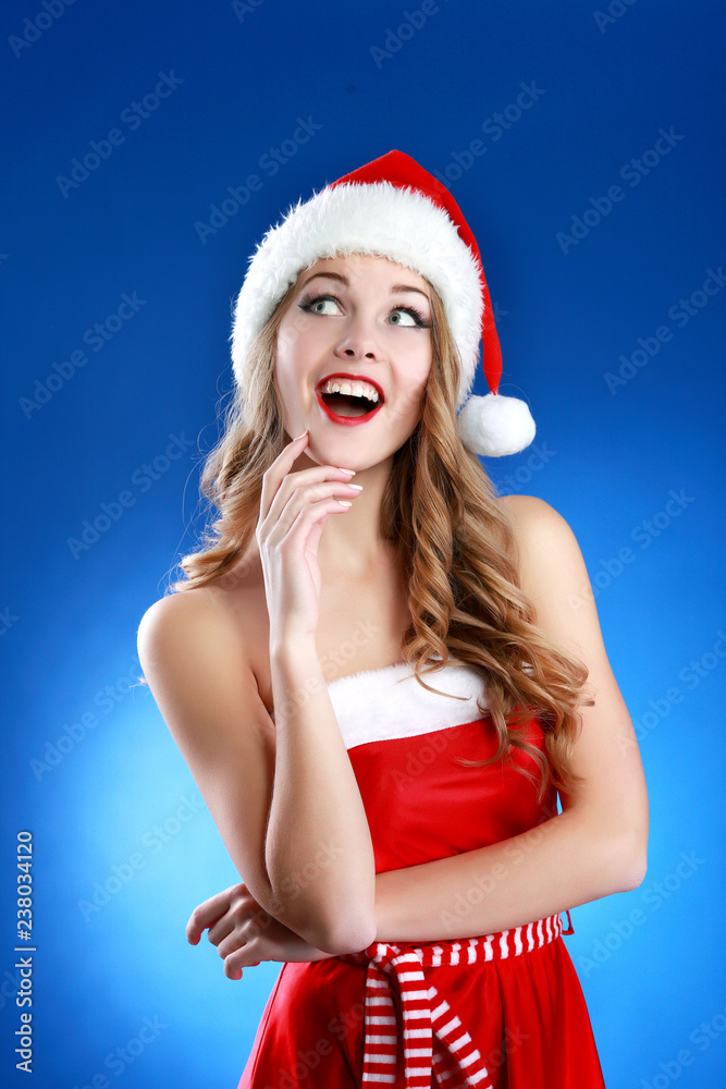 Portrait of a beautiful woman wearing a santa hat smiling Portrait of a beautiful woman wearing a santa hat smiling
