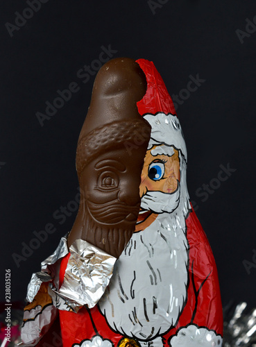 unwrapped chocolate santa claus, Bipolar disorder mental health concept photo