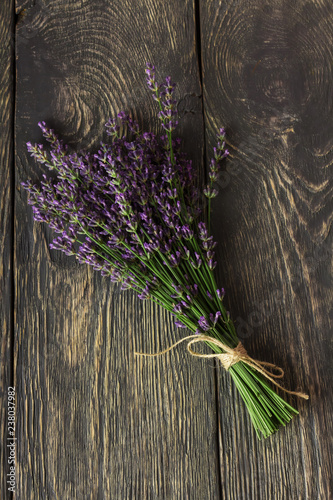 Fototapeta Naklejka Na Ścianę i Meble -  Fresh, fragrant bouquet of lavender on background of dark boards
