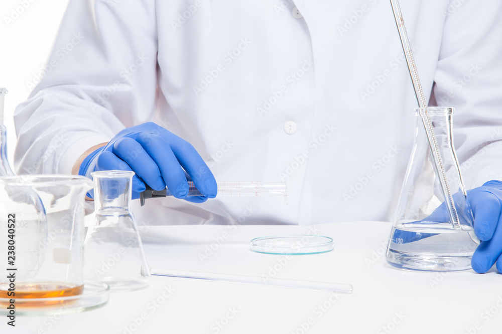view of a human hands in the laboratory while performing experiments view of a human hands in the laboratory while performing experiments