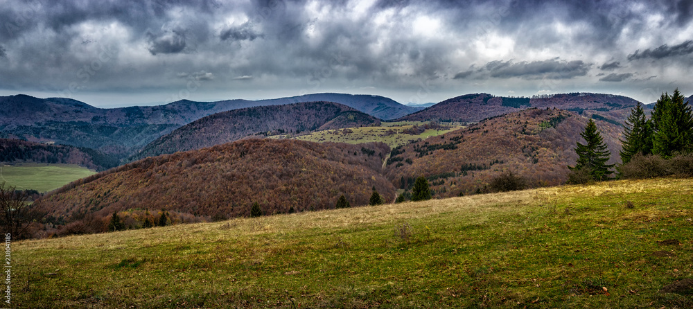 Fototapeta premium Mountain landscape in autumn.Mountain forest landscape under evening sky with clouds in sunlight.Natural outdoor travel background.Autumn mountain landscape in Slovakia.