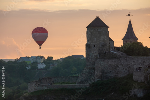 Air balloon flies close to walls of medieval Castle Kamianets-Podilskyi