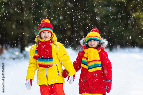 Kids winter snow ball fight. Children play in snow
