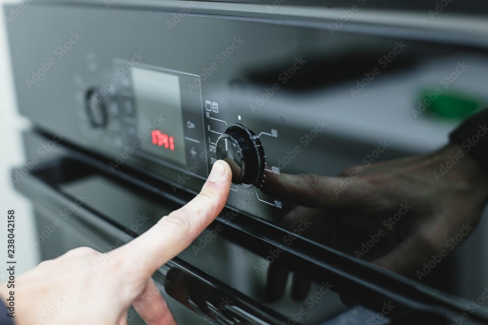  turning on the oven, pressing the finger on the button. Cooking