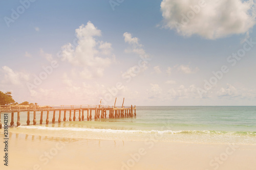 Beauty sand beach with fishing jetter with blue sky background photo