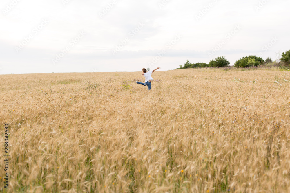 the guy jumps . boy in wheat field. child. wheat field