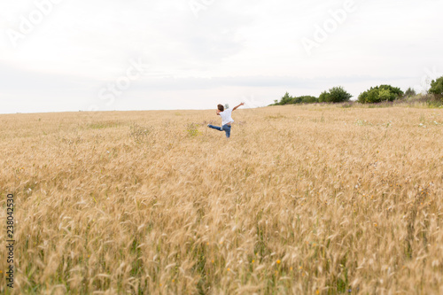 the guy jumps . boy in wheat field. child. wheat field