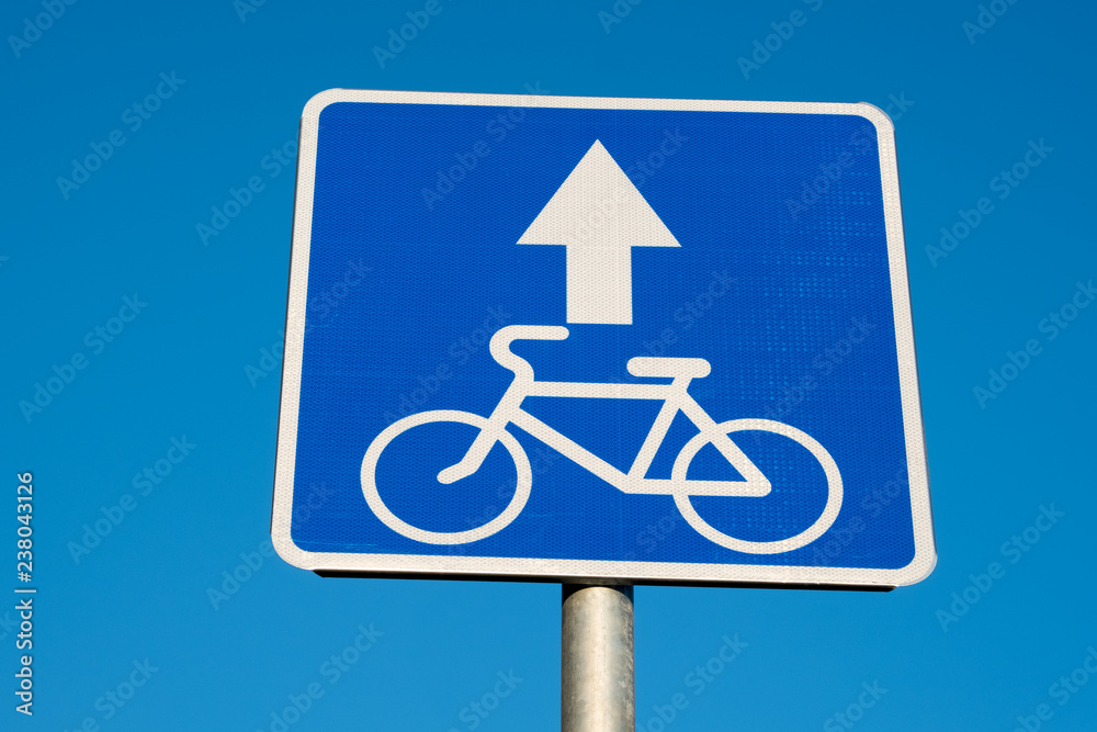 Bike path sign on a blue sky background
