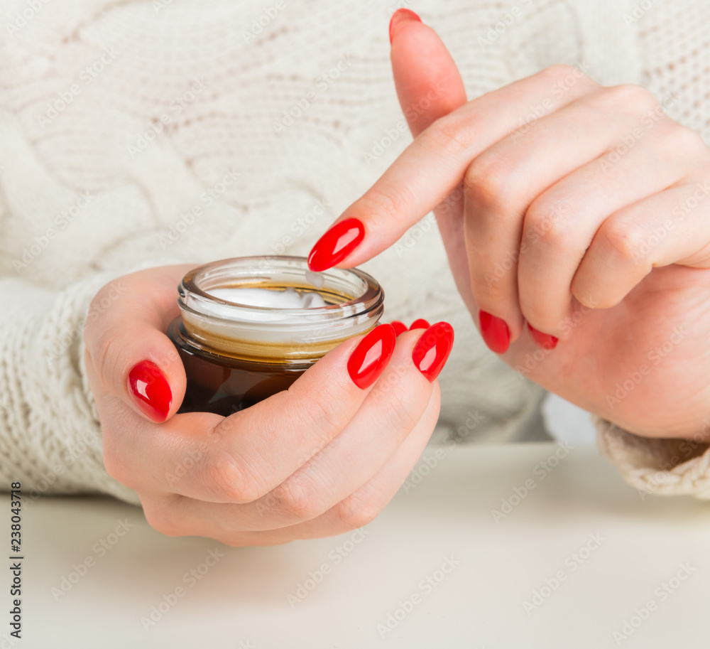 female hands with the jar of cream female hands with the jar of cream