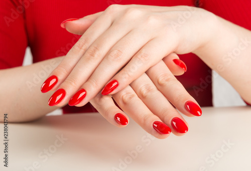 female hands with red manicure..