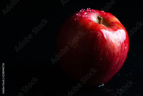 ripe red apple on black background 