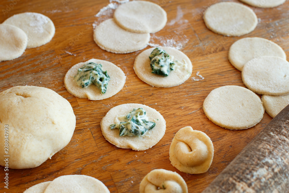 Making ravioli with ricotta cheese and spinach