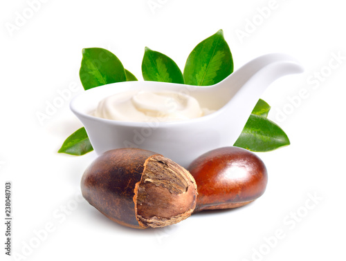 Photos Shea nuts with butter or cream in the bowl. Isolated on white ba