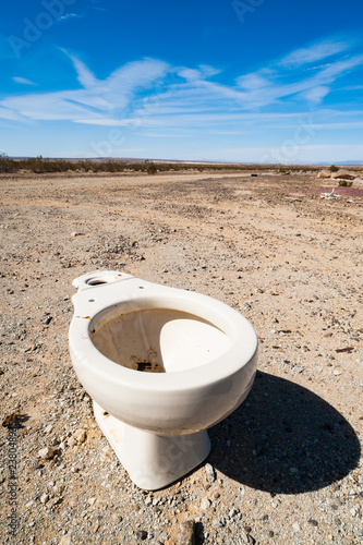 Ceramic toilet bowl dumped in the desert