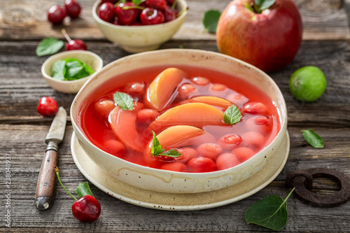 Sweet fruit soup with cherries, apples and mint
