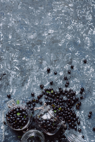   Juicy fresh blueberries on gray concrete background. Picked bilberries in bowl close up. Place for text. Top view 