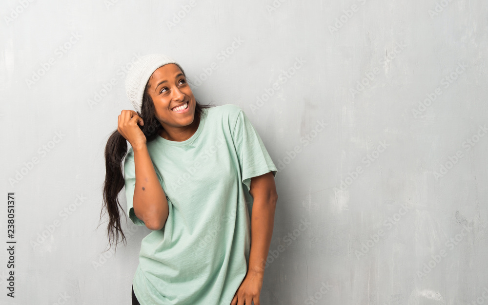Young afro american woman on textured background thinking an idea while scratching head Young afro american woman on textured background thinking an idea while scratching head