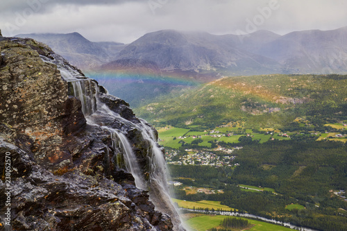 mountain landscape with hydenfossen waterfall  the end of earth  rainbow