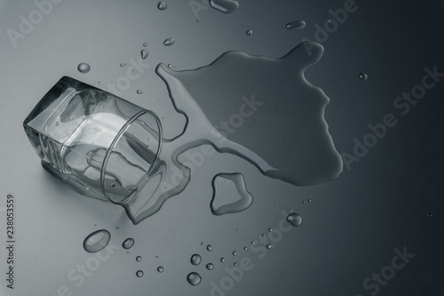 close up of a glass of water spilled on the table