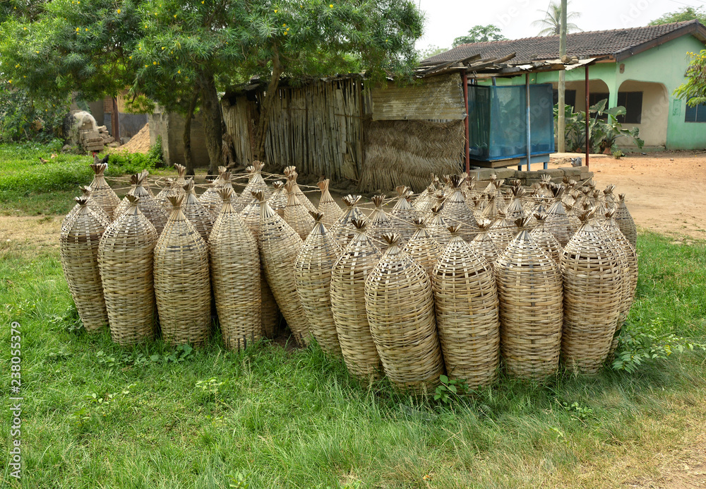 Coop-like traps to catch fish. Wooden fish traps for sale in a yard in West  Africa. Typical woven crustacean fishing trap. West Africa, Ghana Stock  Photo