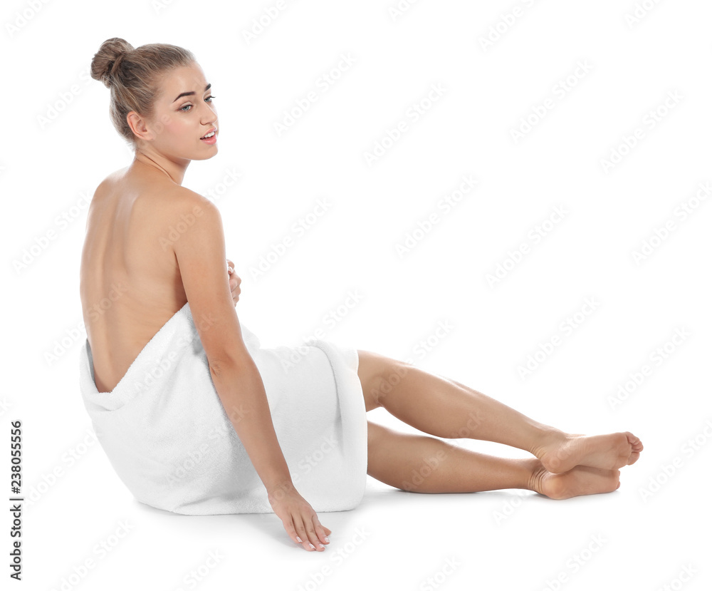 Obraz premium Young woman with soft towel sitting on white background