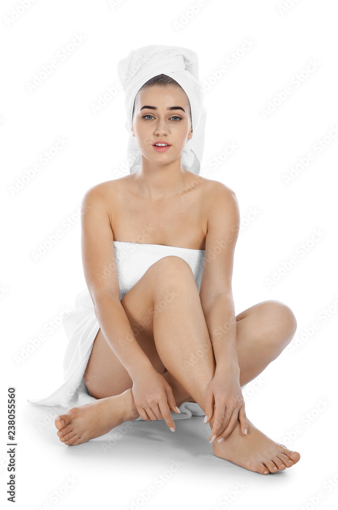 Portrait of young pretty woman with towels sitting on white background Portrait of young pretty woman with towels sitting on white background