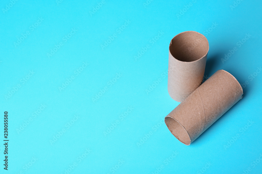 Empty toilet paper rolls and space for text on color background Empty toilet paper rolls and space for text on color background