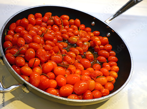 Kitchen pan with sauteed red grape tomatoes