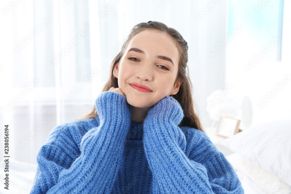 Beautiful teenage girl in warm cozy sweater at home Beautiful teenage girl in warm cozy sweater at home