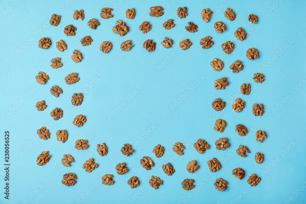 Flat lay composition with tasty walnuts and space for text on color background Flat lay composition with tasty walnuts and space for text on color background