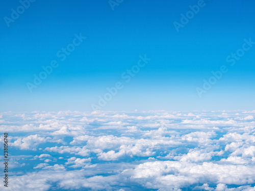 Aerial view of blue sky and white Clouds. Top view from airplane window