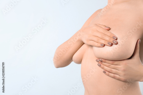 Wallpaper Mural Woman checking her breast and space for text on white background, closeup Torontodigital.ca