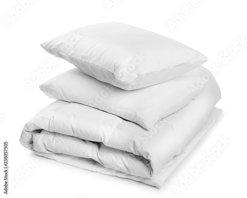 Clean blanket and pillows on white background