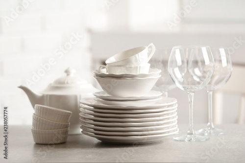 Set of clean dishes against blurred background