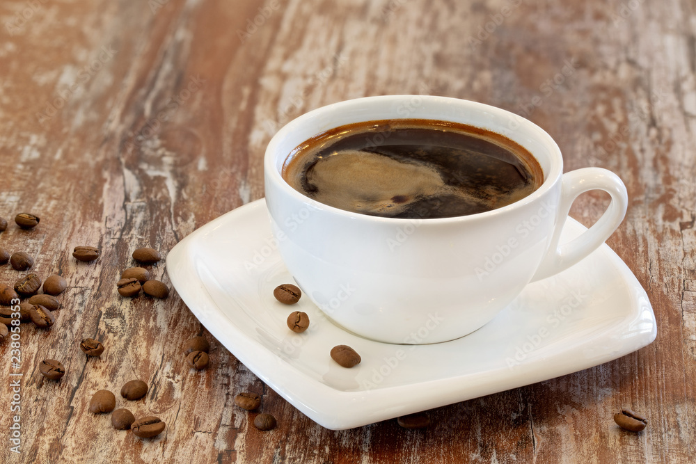Black coffee in a cup on a wooden background Black coffee in a cup on a wooden background