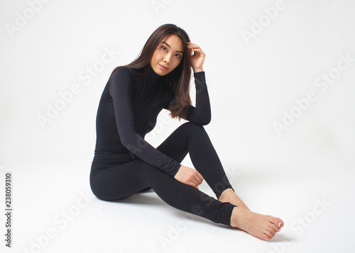 young slim asian woman in black suit posing isolated on white background  Stock Photo