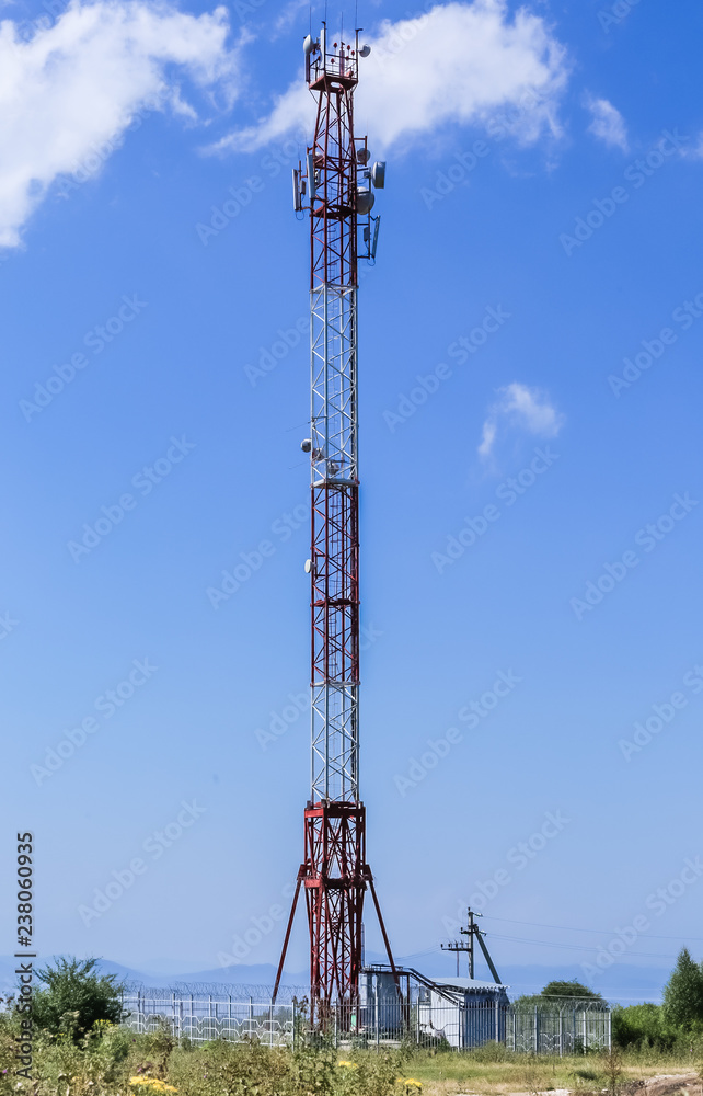 Communications tower on top of a hill complete with various antennas and microwave and satellite dishes Communications tower on top of a hill complete with various antennas and microwave and satellite dishes