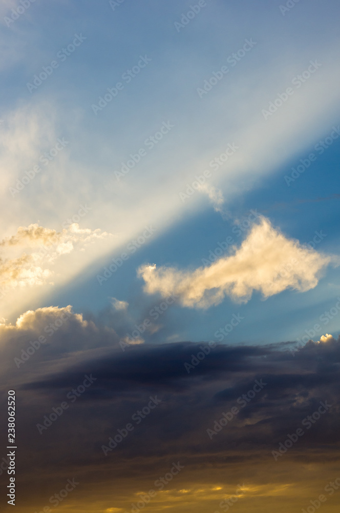 Landscape with dramatic light - beautiful golden sunset with saturated sky and clouds.