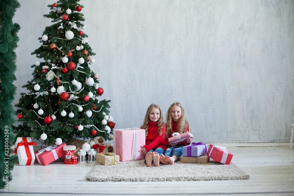 two small girls blonde in red dress at Christmas gifts new year holiday two small girls blonde in red dress at Christmas gifts new year holiday