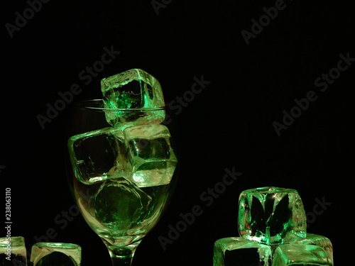 Dark and Dirty Ice Cubes in a Wine Glass, Depicting Square Shaped Germ Infested Frozen Water.