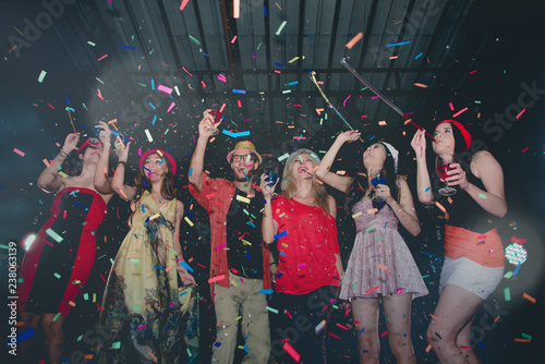 Cheerful Party People Dancing and Throwing Colorful Confetti in Nightclub - Lifestyle on Holiday
